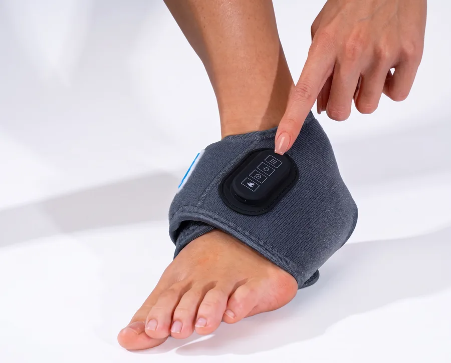 A finger pressing the EMSense control panel on the wrap