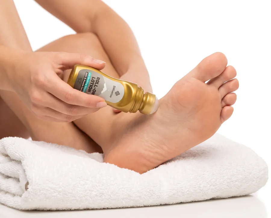 Rolling EMSense Roll-On Lotion across the sole of a foot