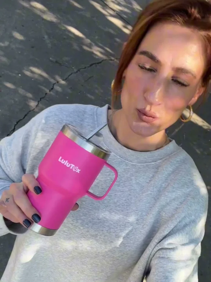 A creator drinking from her Lulutox tumbler outdoors