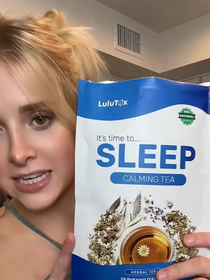 A creator holding the Lulutox Sleep Tea pouch