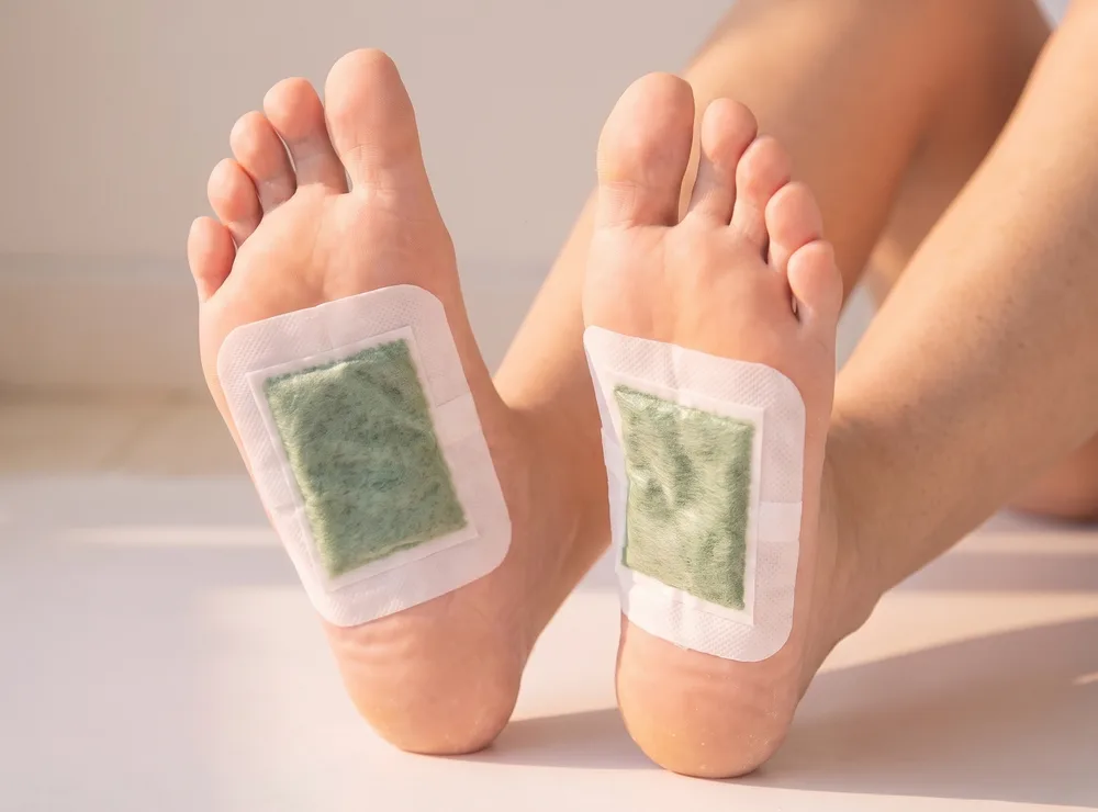 Bandoo patches worn on the soles of the feet